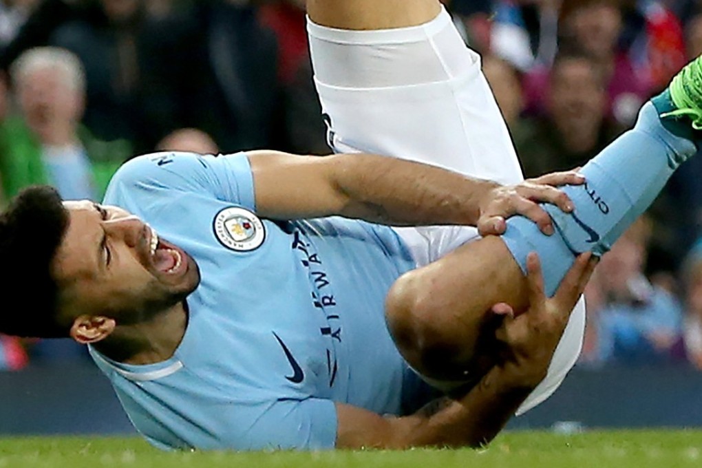 Sergio Aguero reacts after a challenge by Manchester United’s Ashley Young. Photo: EPA