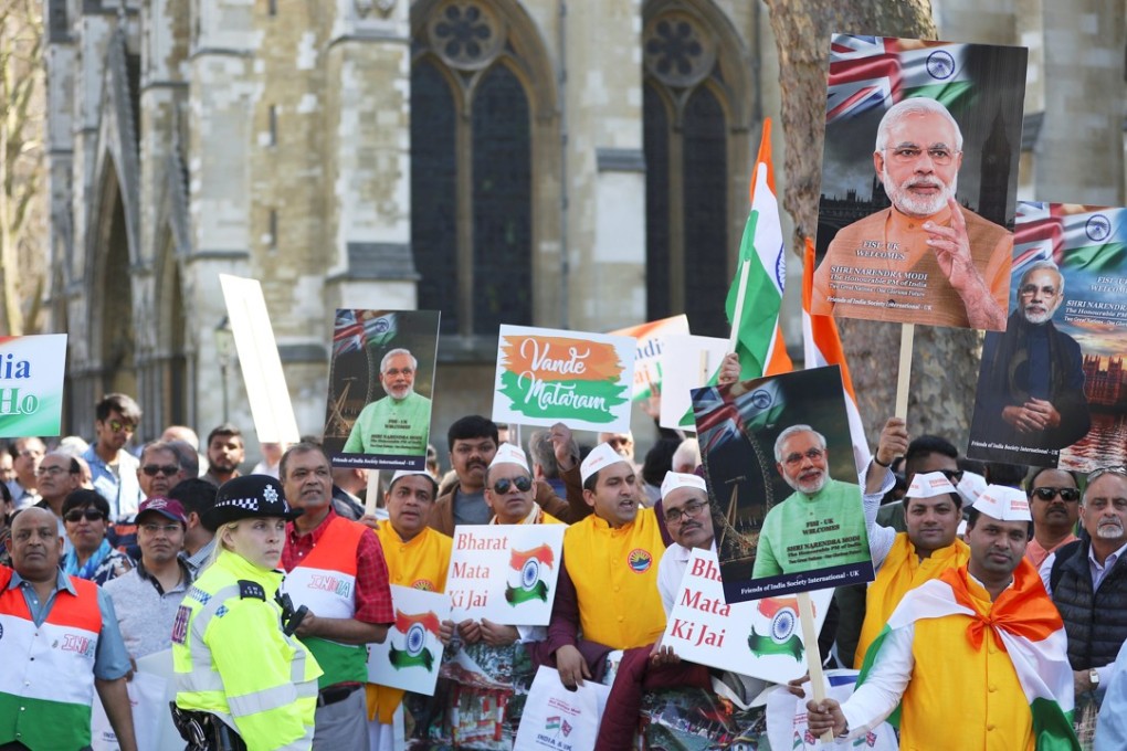 Demonstrators holds placards and pictures of India's Prime Minister Narendra Modi in Parliament Square on Wednesday. Photo: Reuters