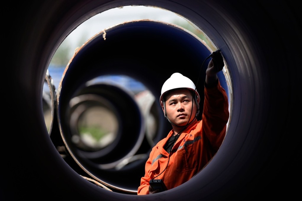 A worker measures a steel pipe at a factory in Zouping, Shandong province, on April 18. US President Donald Trump has imposed tariffs of 25 per cent on steel imports and 10 per cent on aluminium imports. Photo: AFP