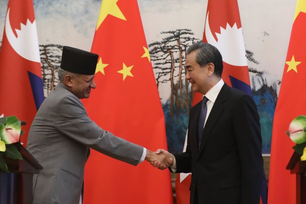 Chinese Foreign Minister Wang Yi (right) shakes hands with his Nepali counterpart Pradeep Kumar Gyawali after a press conference in Beijing on Tuesday. Photo: EPA-EFE