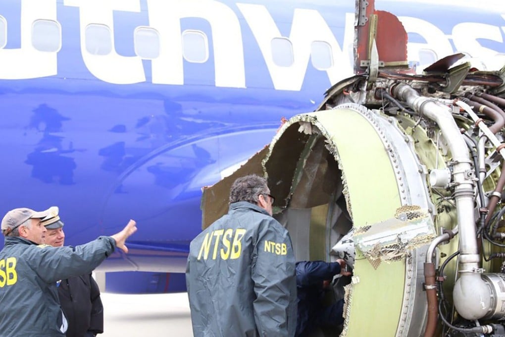 National Transportation Safety Board investigators examine a damaged Southwest Airlines plane that made an emergency landing in Philadelphia after an engine exploded. Photo: NTSB via AFP