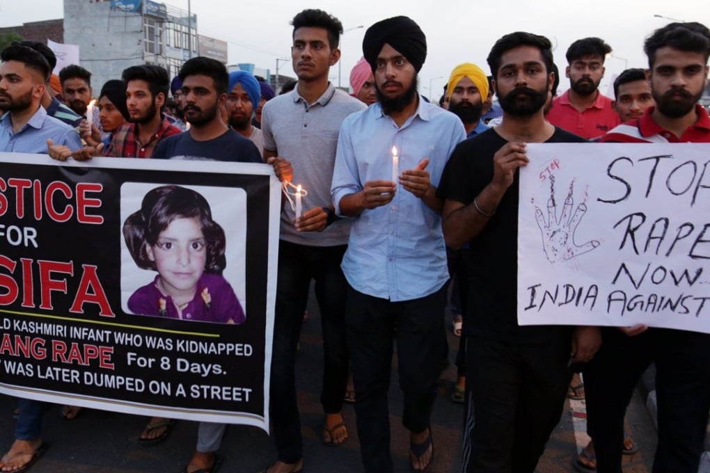 Indian students hold a banner with a photo of Asifa Bano, posters and candles during a march to protest against the rape and murder of eight-year-old Asifa Bano, in Amritsar, India. Photo: EPA
