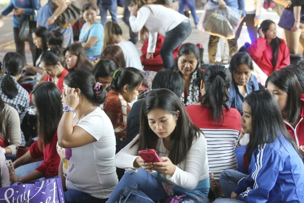 Domestic helpers enjoy a day off, in Central last November. Photo: Dickson Lee