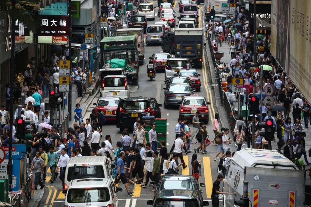 Pedestrians and vehicles jostle for space in Central. Photo: Jonathan Wong