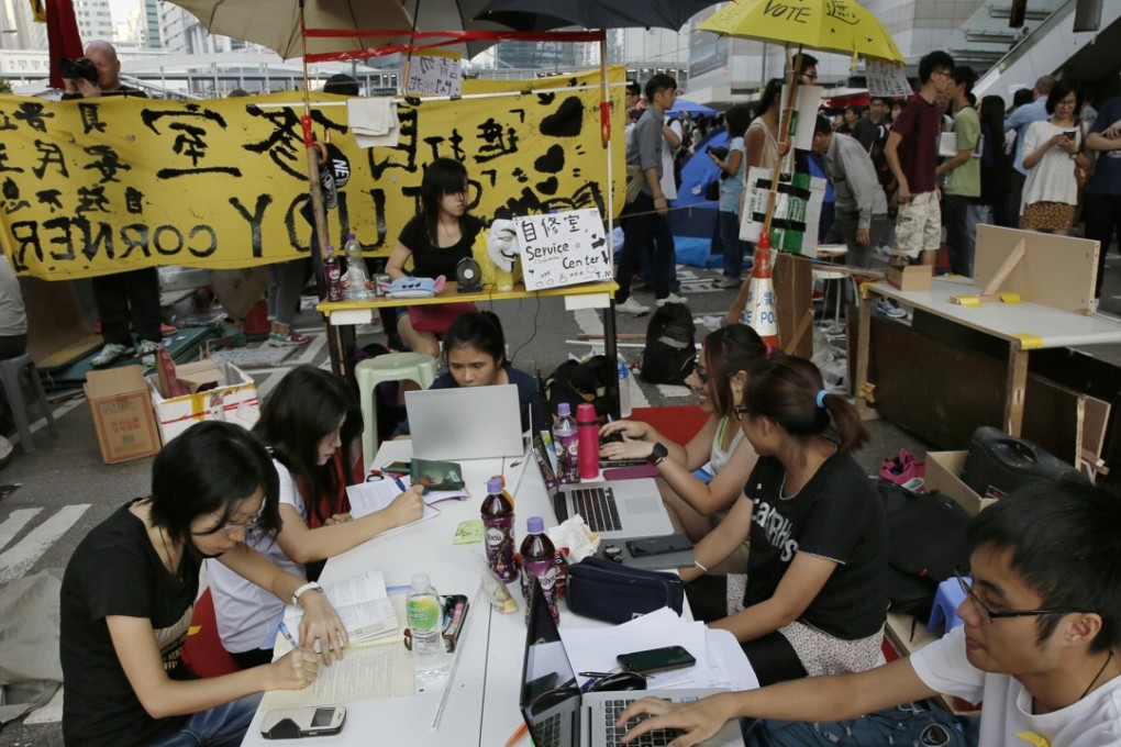 Students do their homework on the streets of Admiralty in October 2014, during the Occupy movement. Photo: AP