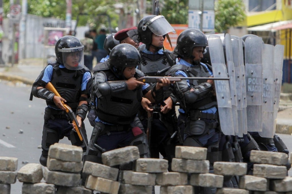Nicaraguan riot police clash with students in front of the Engineering University during protests against government reforms. Photo: Agence France-Presse