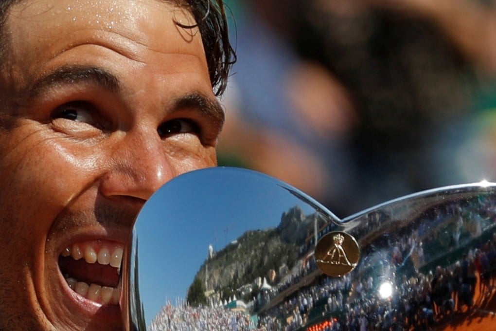 Spain's Rafael Nadal celebrates with the trophy after winning the final against Japan's Kei Nishikori. Photo: Reuters