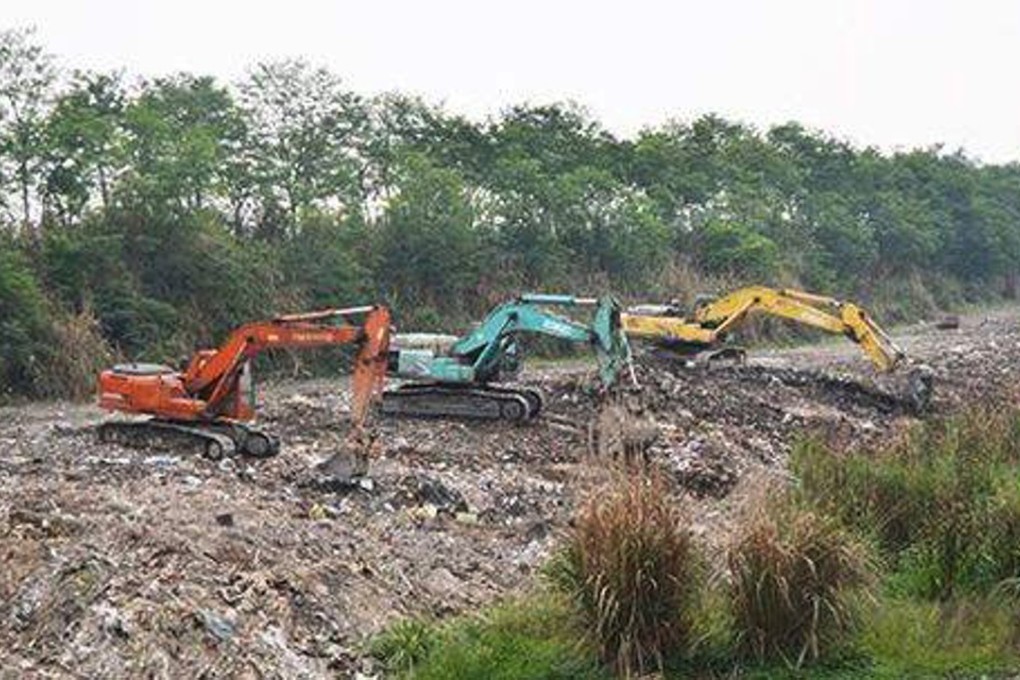 Excavators clear some of the household and construction waste that had built up over years at the pond in Shuangliu district in Chengdu. Photo: Sina