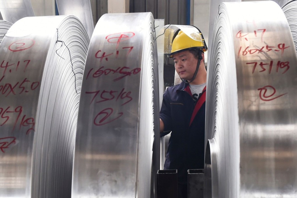 A worker checks rolls of aluminium at a factory in Zouping in China's eastern Shandong province last week. Photo: Agence France-Presse