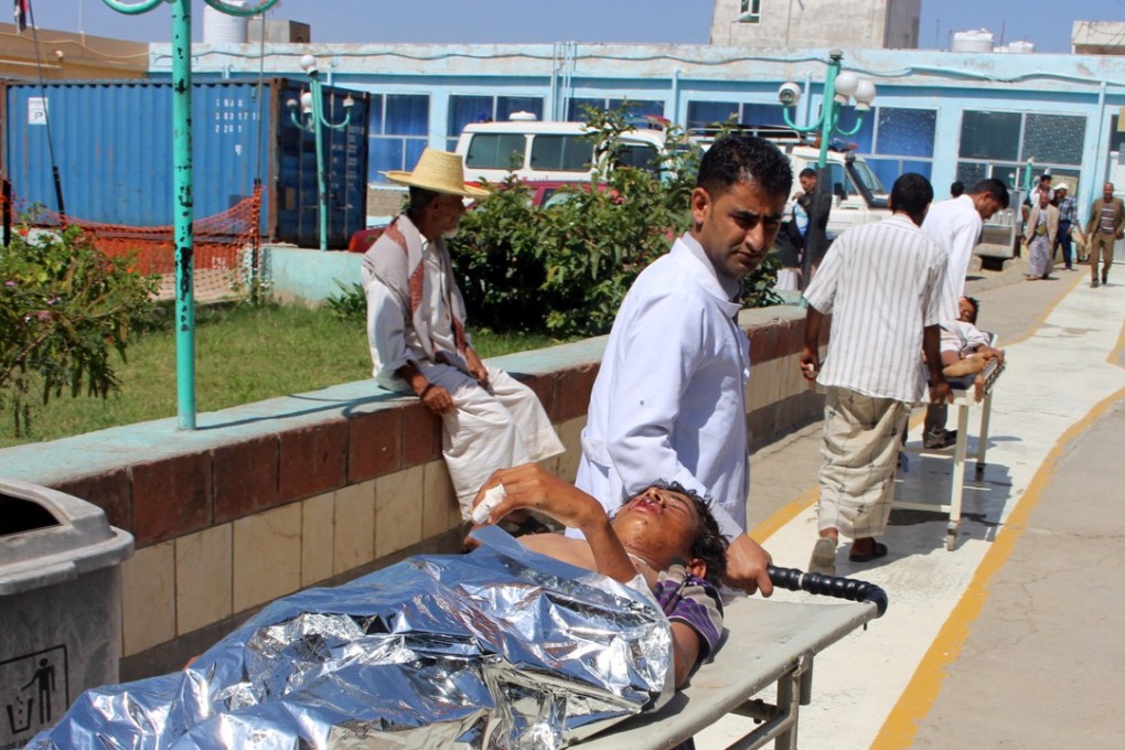 A nurse rushes a boy injured by the attack on a wedding in a village in northwestern Yemen. Photo: Reuters