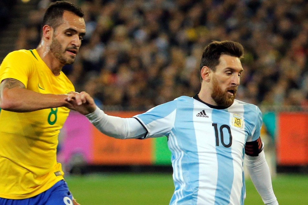 Argentina's Lionel Messi grapples with Brazil's Renato Augusto. Photo: Reuters