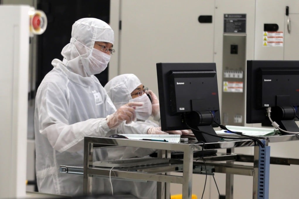 Chinese employees dressed in dust-proof clothing work at a plant of Semiconductor Manufacturing International Corp in Beijing. China’s chip industry has become closer to the world’s first-tier as domestic-made chips are now being used in many industries, according to Diao Shijing, the director of information technology at the Ministry of Industry and Information Technology. Photo: Handout