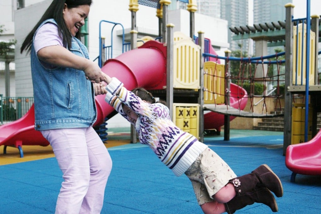 A child plays with the family’s domestic helper. Discriminatory policies at private premises are ironic in Asia’s world city. Photo: Oliver Tsang