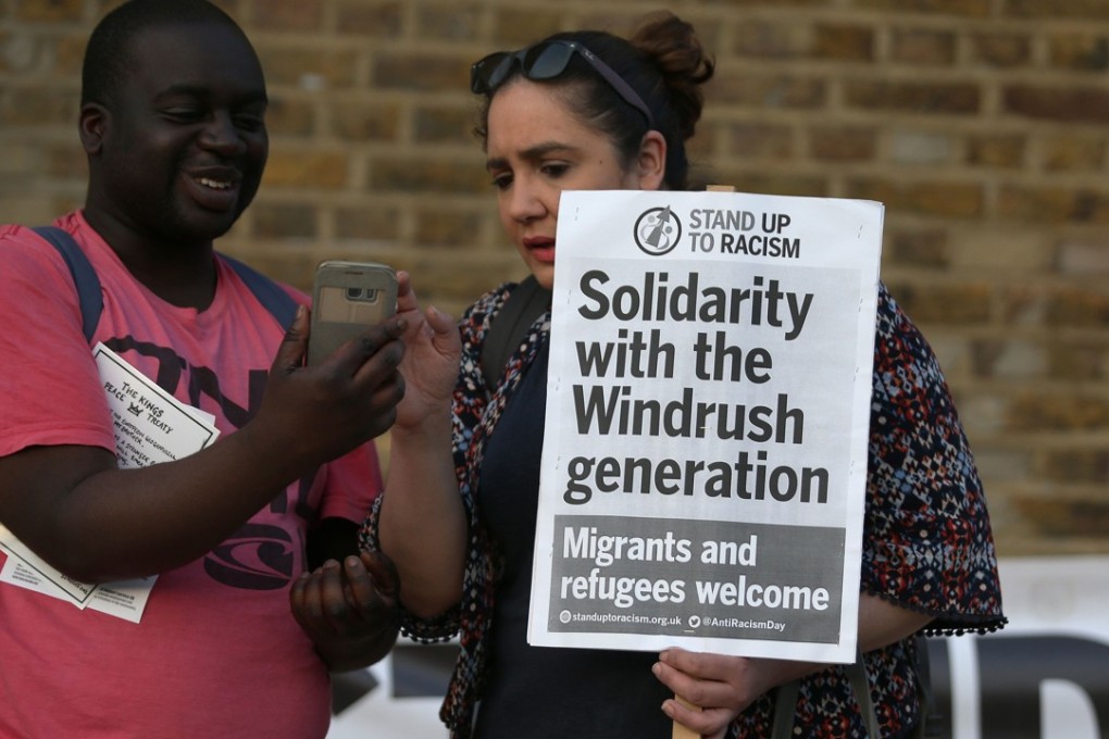 Supporters carry placards at the Windrush generation solidarity protest in the Brixton district ofLondon on Friday. Hundreds of people gathered to support the immigrants as it emerged those caught up in the scandal would be compensated. Photo: AFP