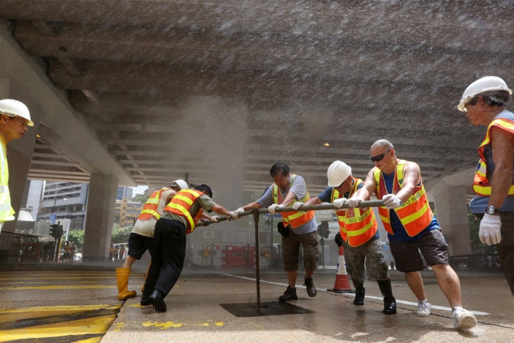 Water Supplies Department workers repair for broken pipe at Canal Road West in Causeway Bay. Photo: Sam Tsang
