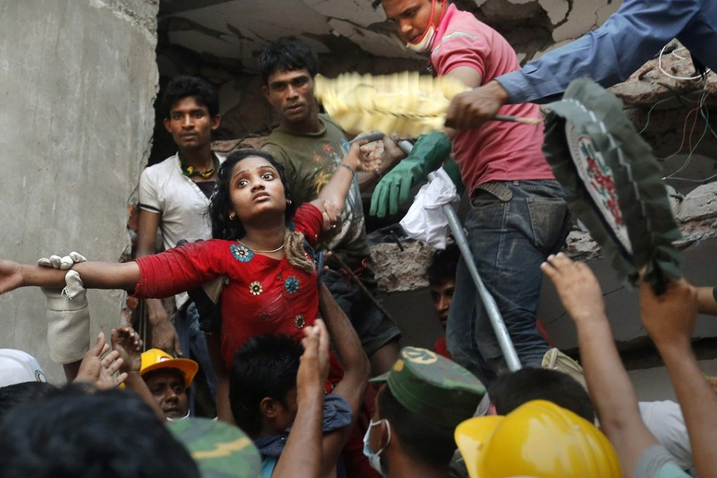 A Bangladeshi woman is lifted out of the rubble by rescuers at the site of the Rana Plaza building that collapsed in Savar, near Dhaka, Bangladesh, on April 25, 2013. Photo: AP