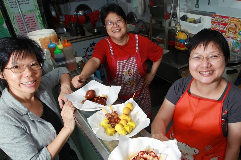 Wu Mei-lin (right) of the Hong Kong Women Workers’ Association poses with two women who took part in management training offered by the association. Photo: May Tse