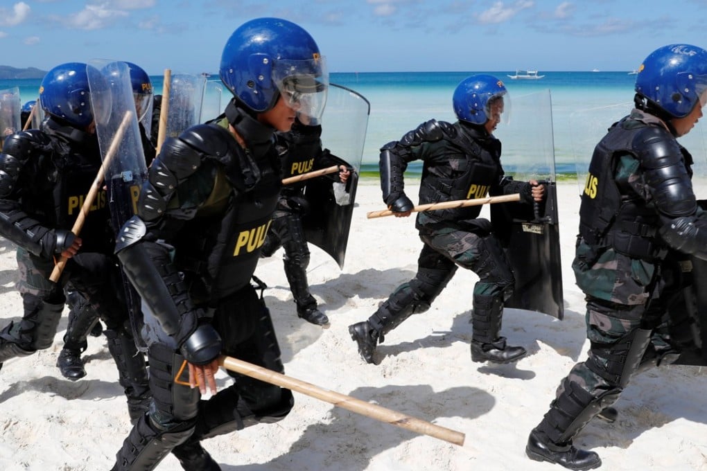 Anti-riot police take part in a simulation of a protest during a military and police drill in preparation for the temporary closure of the holiday island Boracay in Philippines. Photo: Reuters