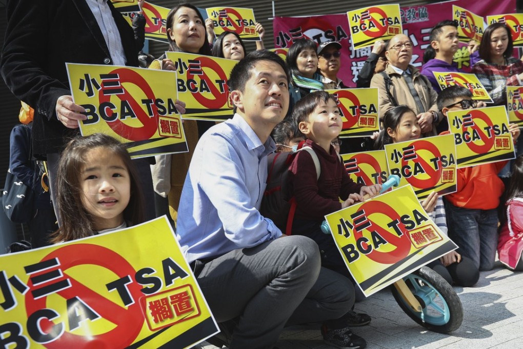 Lawmaker Ted Hui Chi-fung (second left) joins a protest by the anti-TSA alliance of concern groups, mainly made up of students and parents, outside the Hong Kong government headquarters, in Admiralty on February 11. Photo: Nora Tam