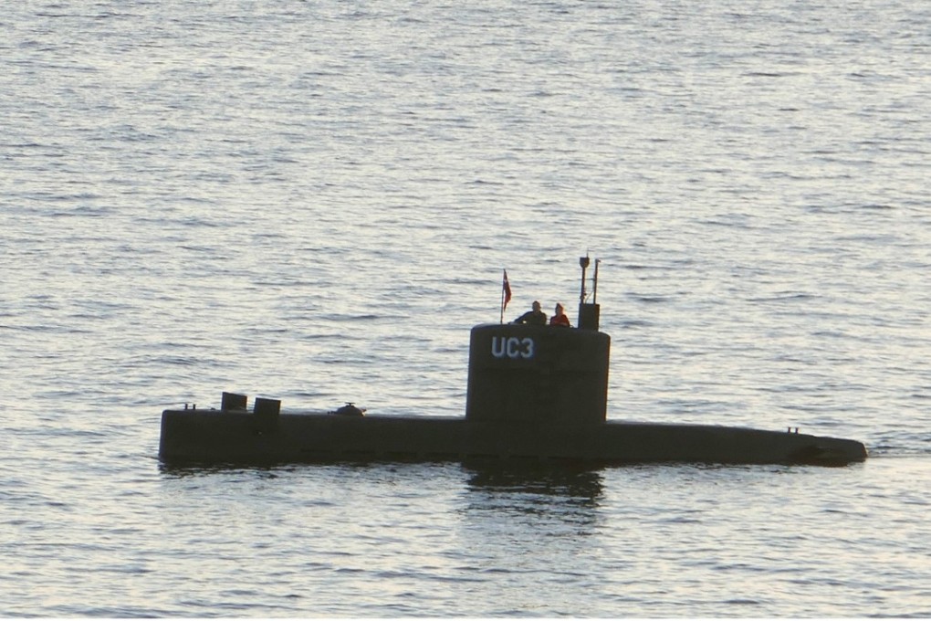 A man and a woman standing in the tower of the private submarine UC3 Nautilus in Copenhagen Harbour. Photo: AFP