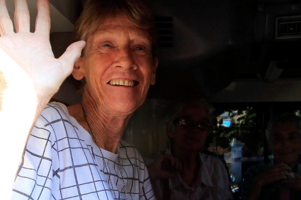 Australian nun Patricia Fox, 71, waves as she leaves the Bureau of Immigration headquarters in Manila. She has been given 30 days to leave the country. Photo: Reuters