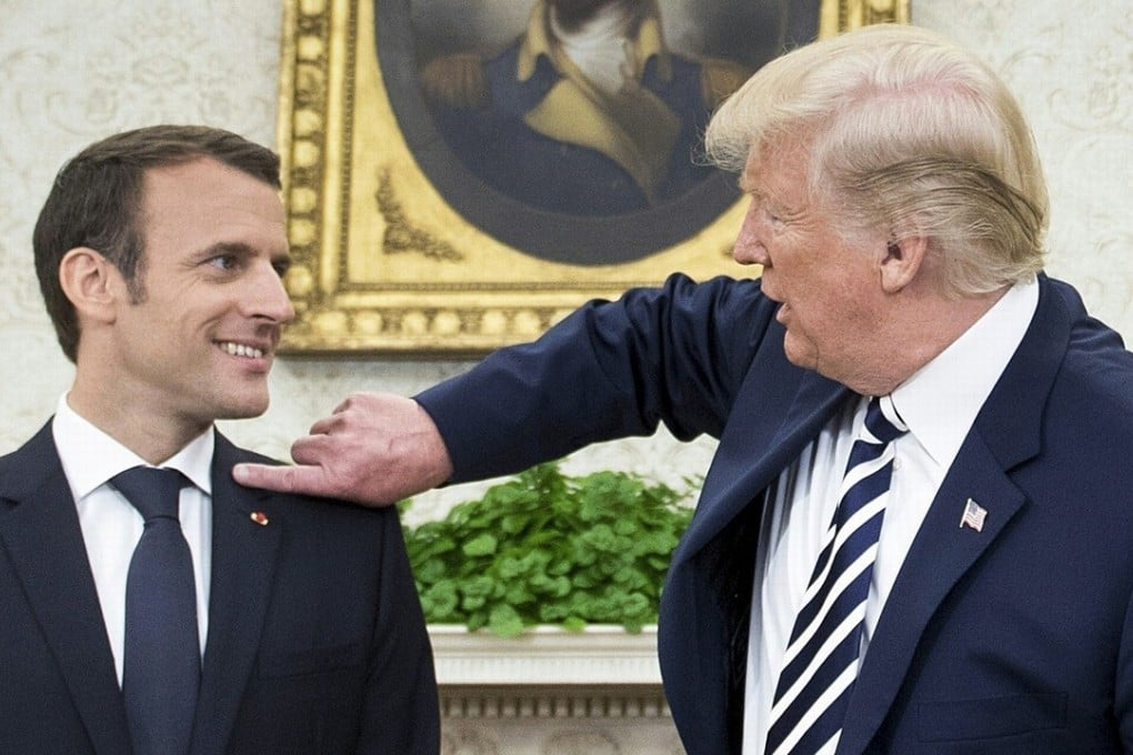 US President Donald Trump (right) claimed he was clearing dandruff from French President Emmanuel Macron's shoulder in the Oval Office before a meeting at the White House on Tuesday. Photo: Agence France-Presse