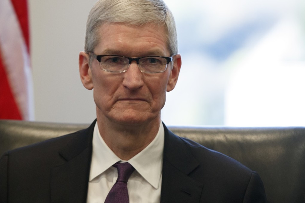Apple CEO Tim Cook listens as President-elect Donald Trump speaks during a meeting with technology industry leaders at Trump Tower in New York. Photo: AP/Evan Vucci