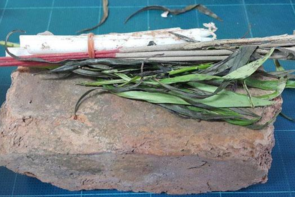 This stolen ancient brick was sent back to the office of the Ayutthaya Historical Park, together with flowers, candles, joss sticks and a letter of apology saying the sender had mysteriously fallen sick. Photo: Sunthorn Pongpao