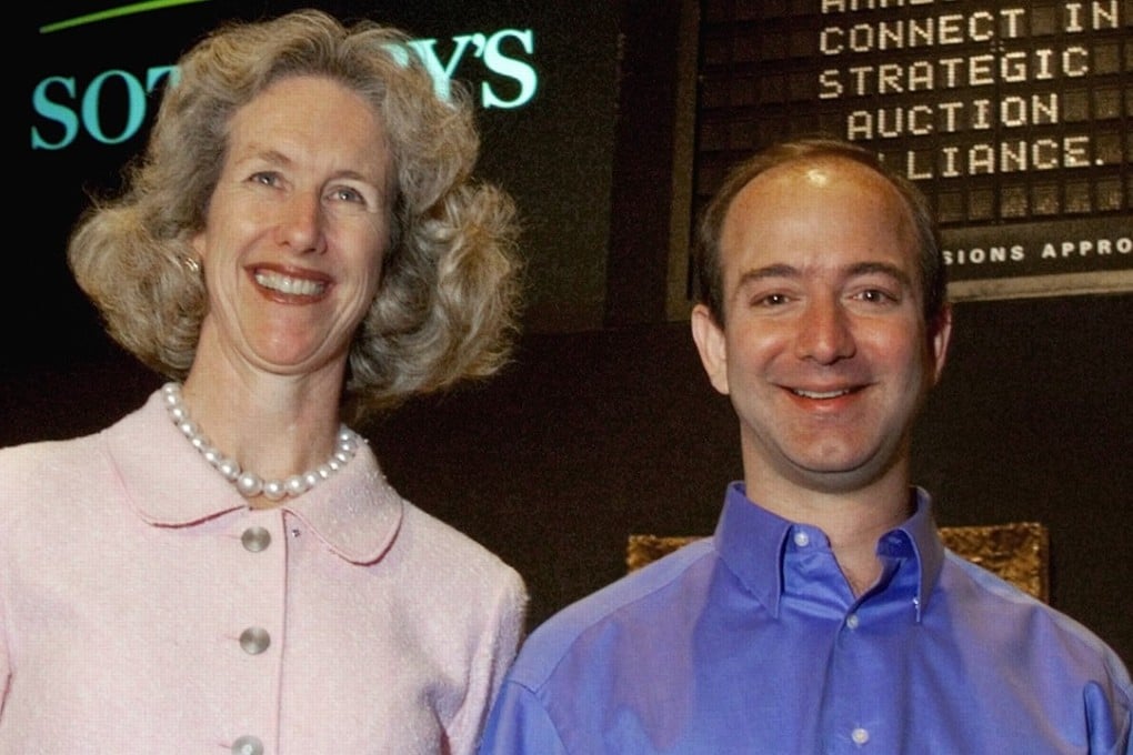 Jeff Bezos, founder and CEO of Amazon.com, and Diana Brooks, president and CEO of Sotheby's, pose for photos after a news conference at Sotheby's in New York, on June 16, 1999. Photo: AP