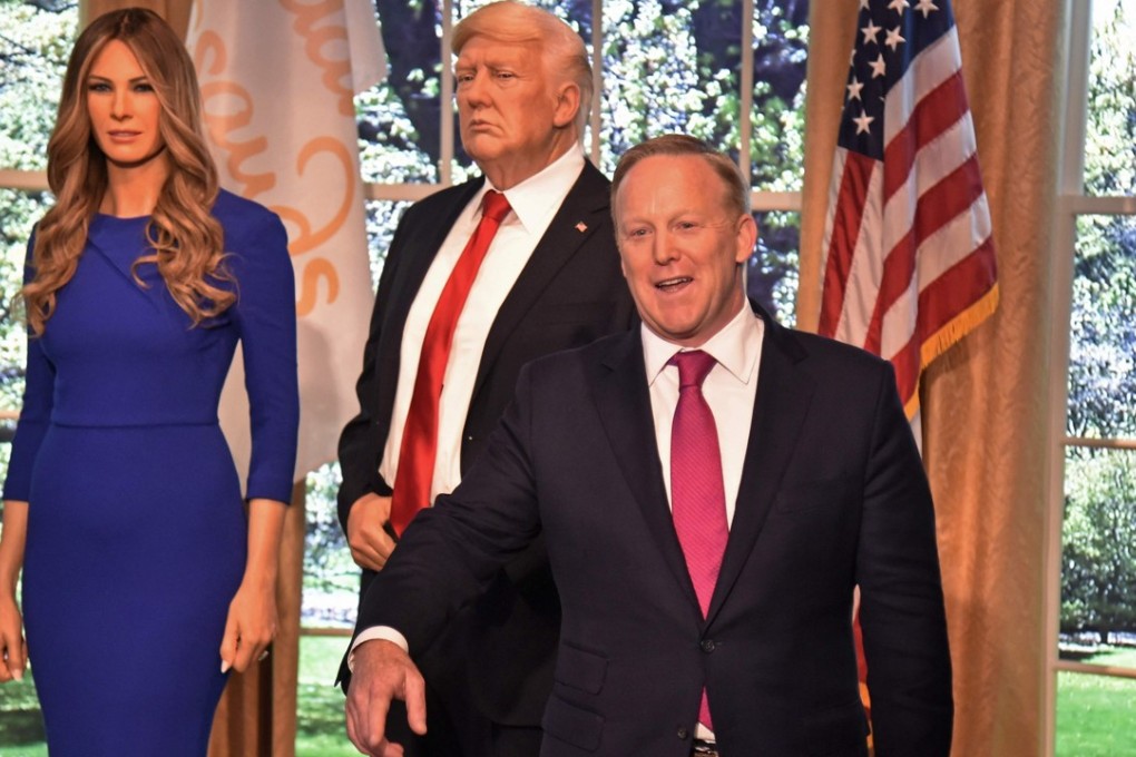 Former White House Press Secretary Sean Spicer poses next to a new wax figure of the First Lady Melania Trump, next to a figure of US President Donald Trump at the Madame Tussauds in New York City on Wednesday. Photo: Agence France-Presse