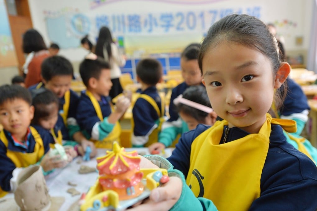 A girl shows her handiwork, made at Huachuanlu Primary School in Qingdao, China, on March 27. China has shown dramatic poverty reduction in recent decades, though reducing it remains a policy priority, especially for the rural areas. Photo: Xinhua