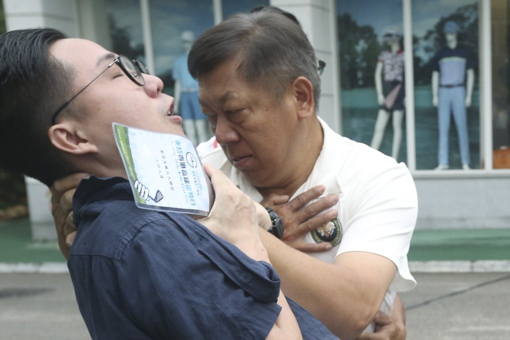 An unidentified man stops Labour Party member Oscar Lo after he entered the Fanling golf course. Photo: Handout