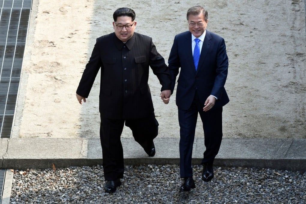 North Korean leader Kim Jong-un (left) and South Korean President Moon Jae-in cross the military demarcation line at the border village of Panmunjom. Photo: AP