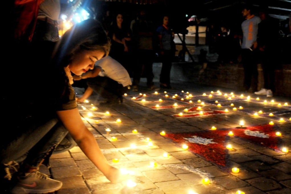 Kathmandu residents take part in a vigil on Wednesday marking the third anniversary of the earthquake that struck Nepal on April 25, 2015, killing almost 9,000 people. Photo: Agence France-Presse