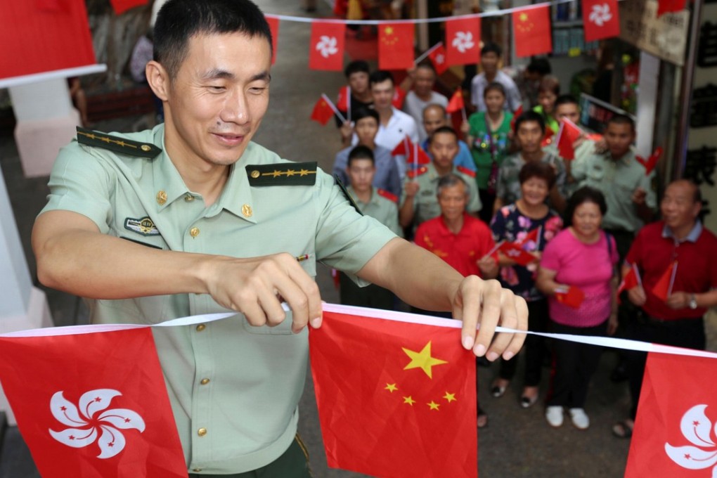 The flags of China and Hong Kong are displayed together in Shenzhen, during an event marking the 20th anniversary of the handover last July. Photo: Reuters