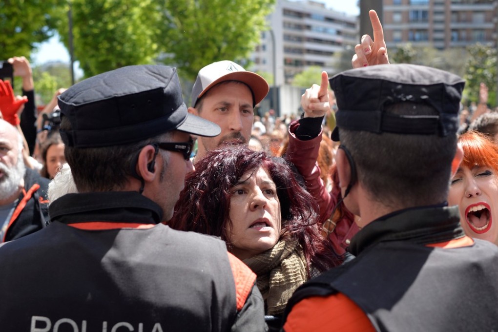 Protesters press up against police after five men accused of the gang rape of a woman during the 2016 San Fermin festival were found guilty of the lesser offence of sexual abuse. Photo: Reuters