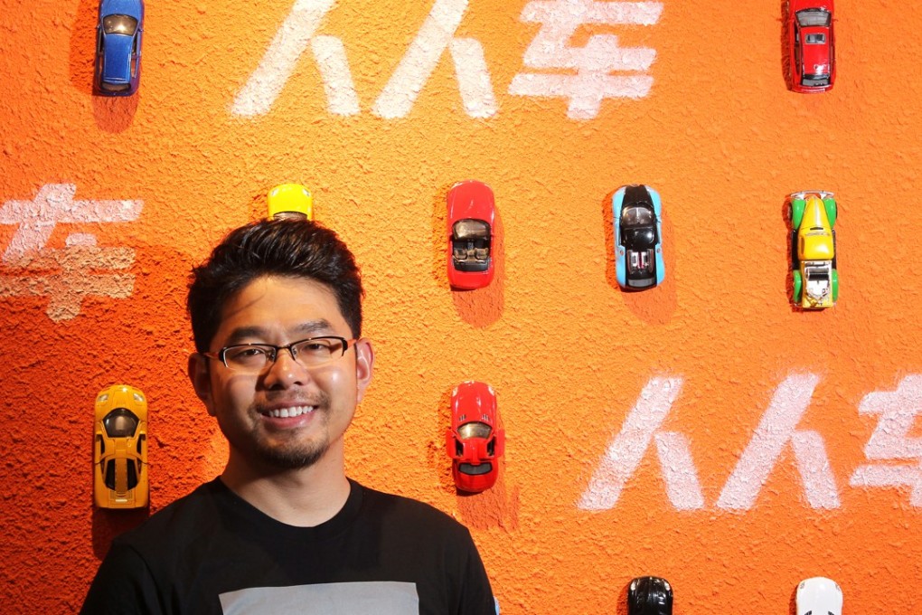 Renrenche founder and CEO Li Jian seen in front of a wall depicting toy cars and the Chinese name of the company. Photo: Simon Song