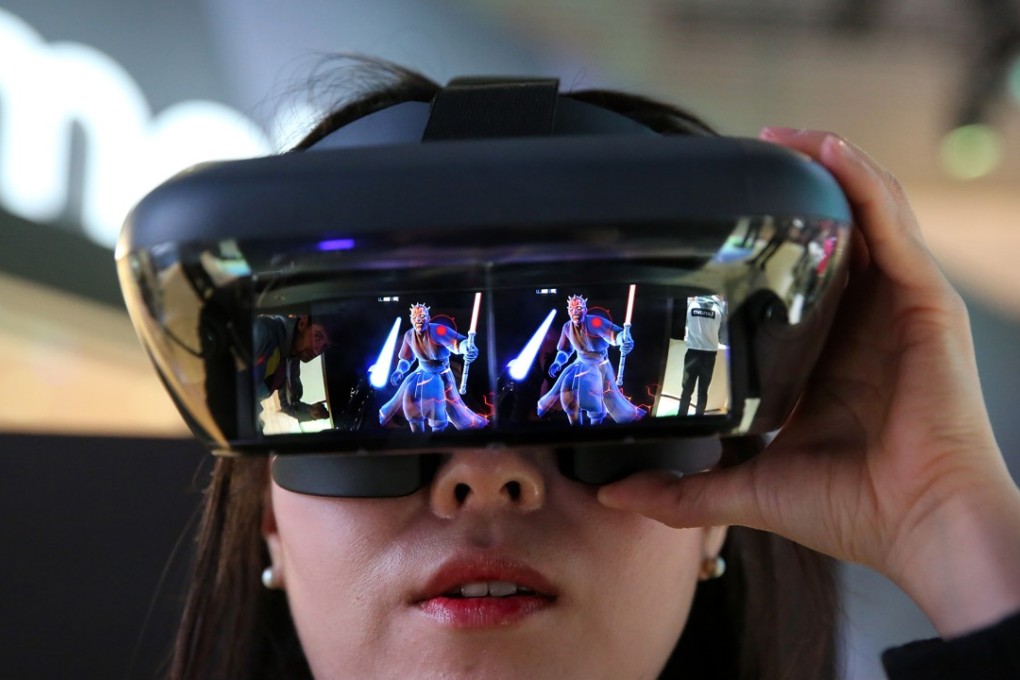 An attendee wears an augmented reality headset while playing the “Star Wars: Jedi Challenges” game during the Mobile World Congress in Barcelona on February 27. Photo: Bloomberg
