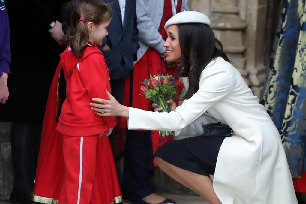 US actress Meghan Markle, the fiancée of Britain's Prince Harry, receives a bouquet from a young girl after attending a Commonwealth Day Service at Westminster Abbey on March 12. The actress bade farewell to her role on the TV show ‘Suits.’ Photo: AFP