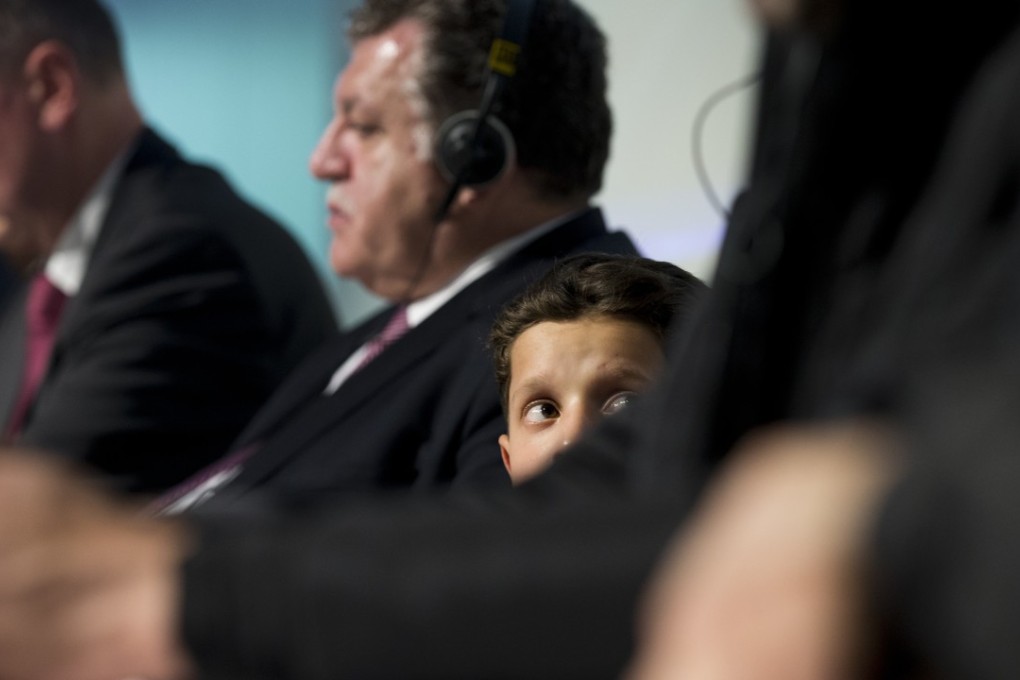 Eleven-year-old Syrian Hasan Diab looks at his image on a screen during a press conference in The Hague organised by Russia in a move to discredit reports of an April 7 chemical weapons attack in the Syrian town of Douma. Photo: AP