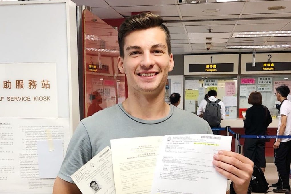 R&F football player Vas Nunez celebrates at immigration with his passport forms. Photos: Handout