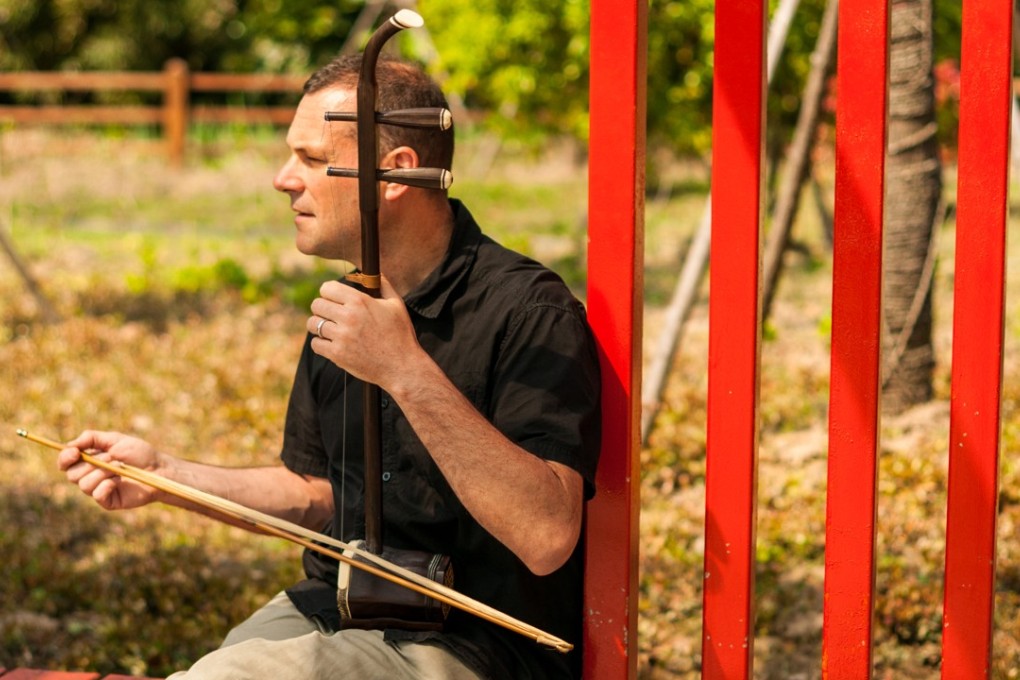 Canadian musician Jeremy Moyer playing the Chinese erhu in a park in Shanghai, China. Photo: Mark Andrews