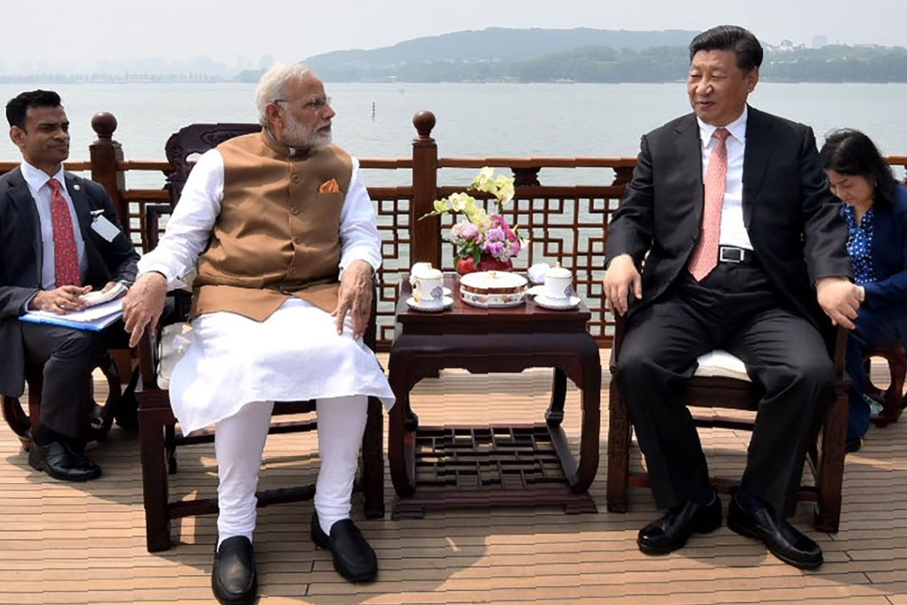 Narendra Modi (left) talks with Xi Jinping by the scenic East Lake in Wuhan on Saturday. Photo: AFP
