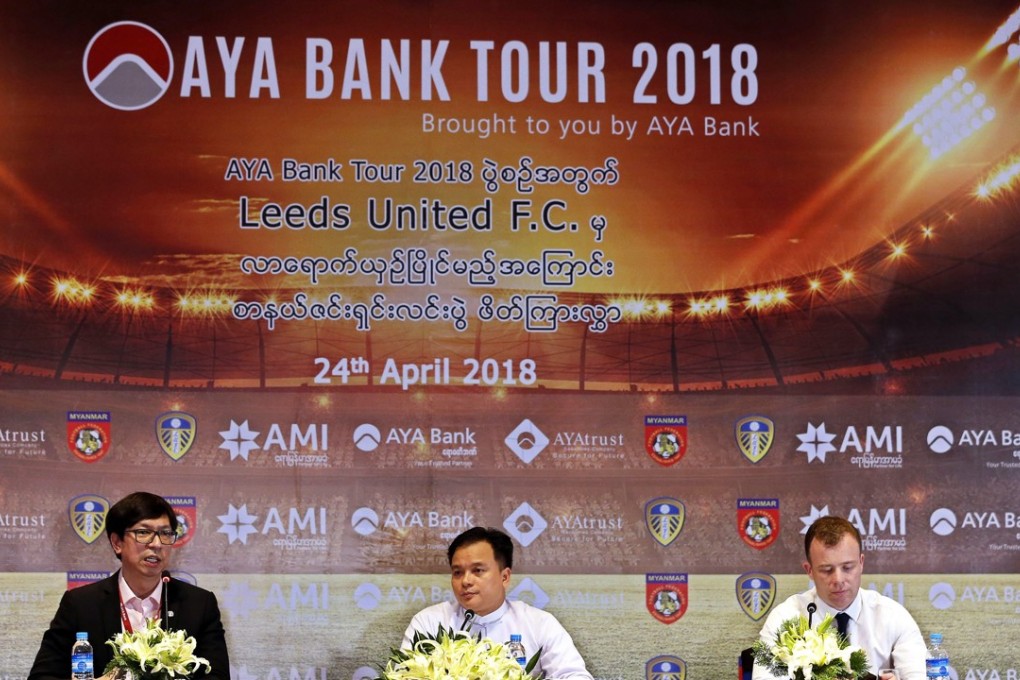 Managing director of AYA Bank Myint Zaw (left), general secretary of the Myanmar Football Federation Ko Ko Thein (centre) and Angus Kinnear, the managing director of Leeds United, attend a press conference in Yangon, Myanmar. Photo: EPA