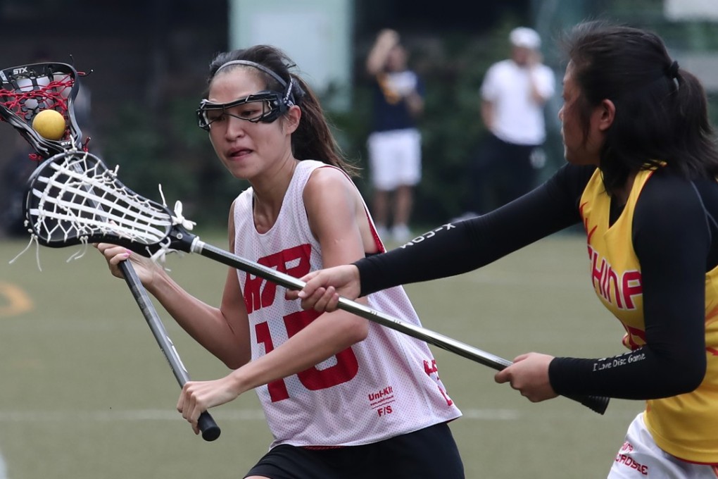 Hong Kong’s Liu Hiu-yan and China’s Yishan Tang at the Hong Kong Lacrosse Open at Stanley Ho Sports Centre in Pok Fu Lam. Photos: Jonathan Wong