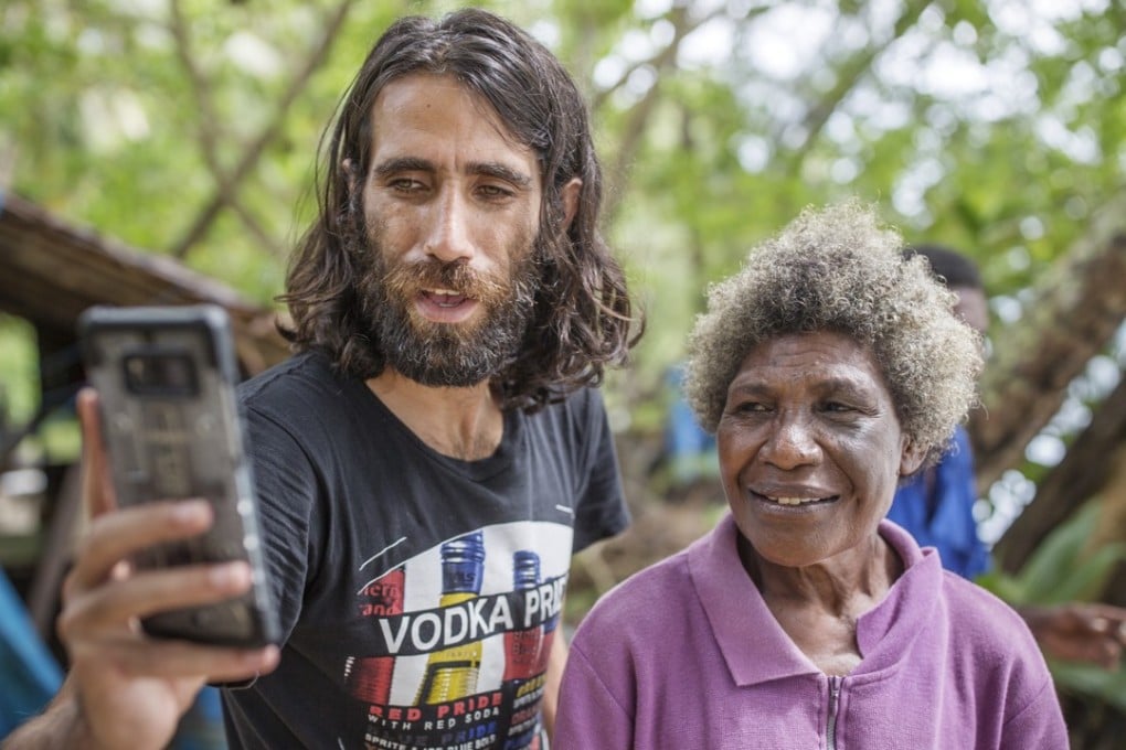 Iranian-born Kurd Behrouz Boochani with a local on Manus Island. Pictures: Jonas Gratzer