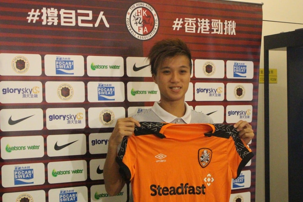 Hong Kong international footballer Cheung Wai-ki poses with a Brisbane Roar shirt. Photo: HKFA