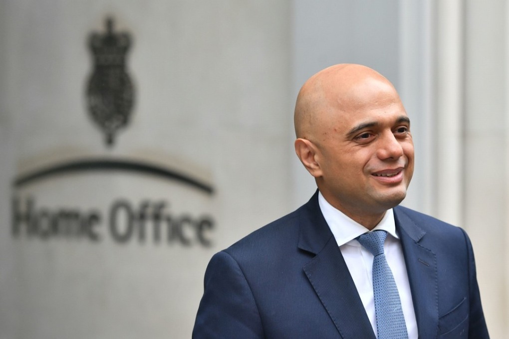 Home Secretary Sajid Javid poses for photos outside the Home Office in Westminster, London. Photo: AP