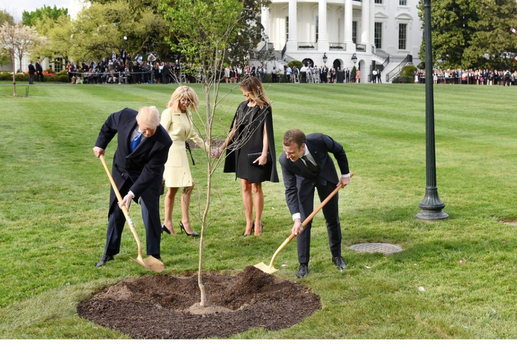 Donald Trump and Melania Trump join French President Emmanuel Macron and his wife Brigitte Macron to plant an oak that the Macrons gave as a gift on the South Lawn of the White House on April 23, 2018. Photo: Abaca Press/TNS