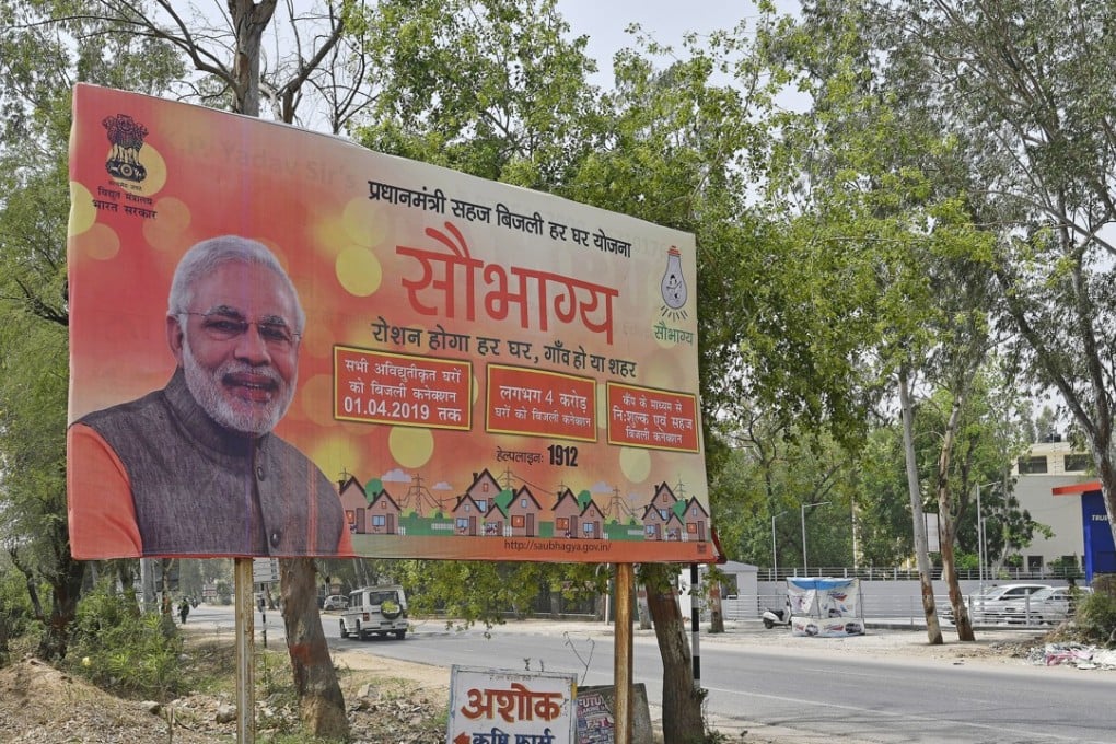 A billboard, featuring an image of Indian Prime Minister Narendra Modi, advertises the Indian government's Saubhagya Scheme, a project to provide electricity to all households. Photo: Bloomberg